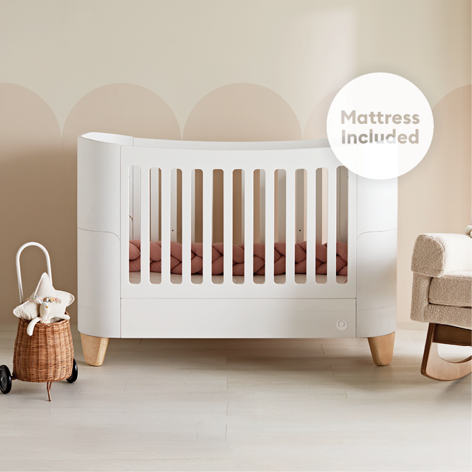 Gaia Baby Serena convertible cot bed in white with natural finish, featuring an included mattress for versatile nursery use.