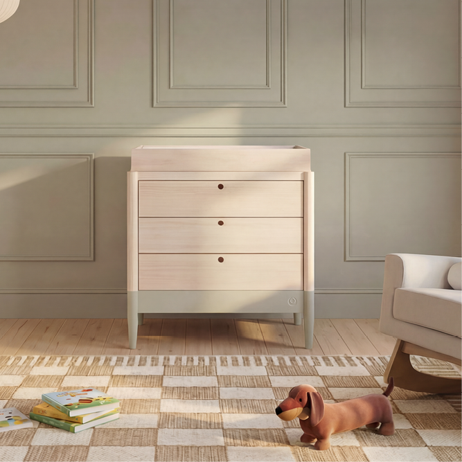 Gaia Baby Eos Dresser in natural finish with Desert Sage accents, showing smooth wooden surface and modern dresser design.
