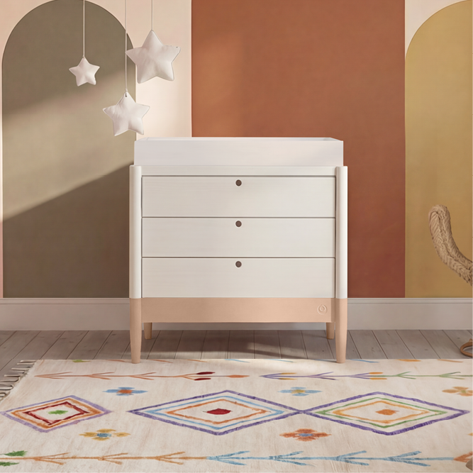 White Gaia Baby Eos Dresser with powder blush finish, featuring sleek drawers and modern design for nursery storage.