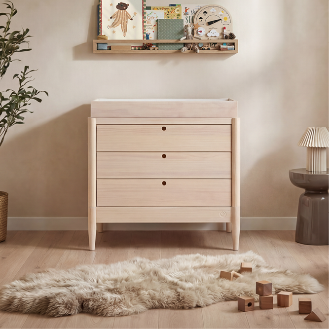 Gaia Baby Eos Dresser in natural wood finish, featuring multiple drawers and a sleek modern design for nursery storage.