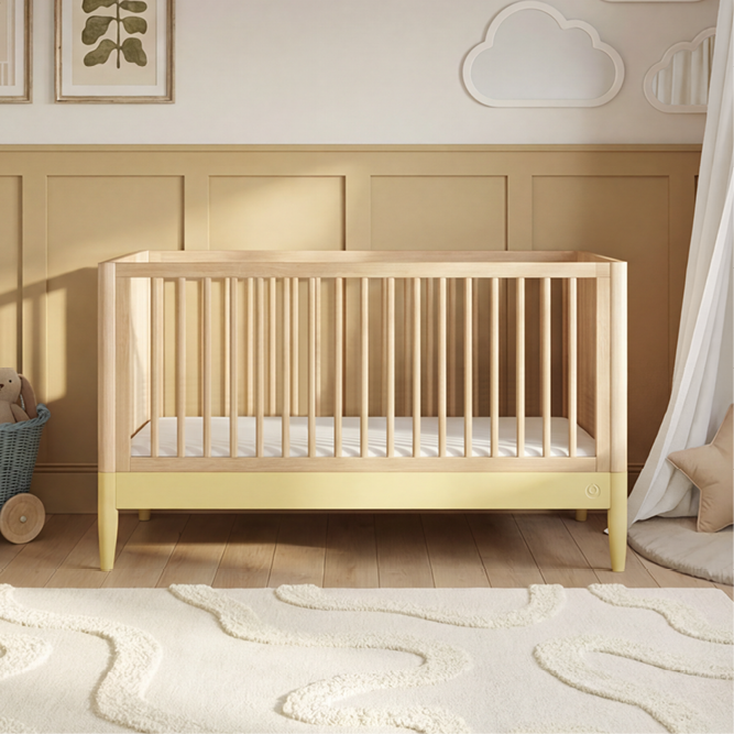 Gaia Baby Eos cot bed in natural wood with saffron yellow accents, showing a sturdy wooden frame and slatted sides for a child’s crib.