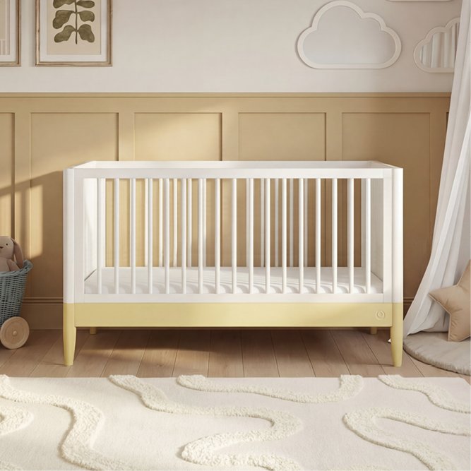 White Gaia Baby Eos cot bed with Saffron Yellow accents, featuring a sturdy wooden frame and slatted sides for safe sleep.