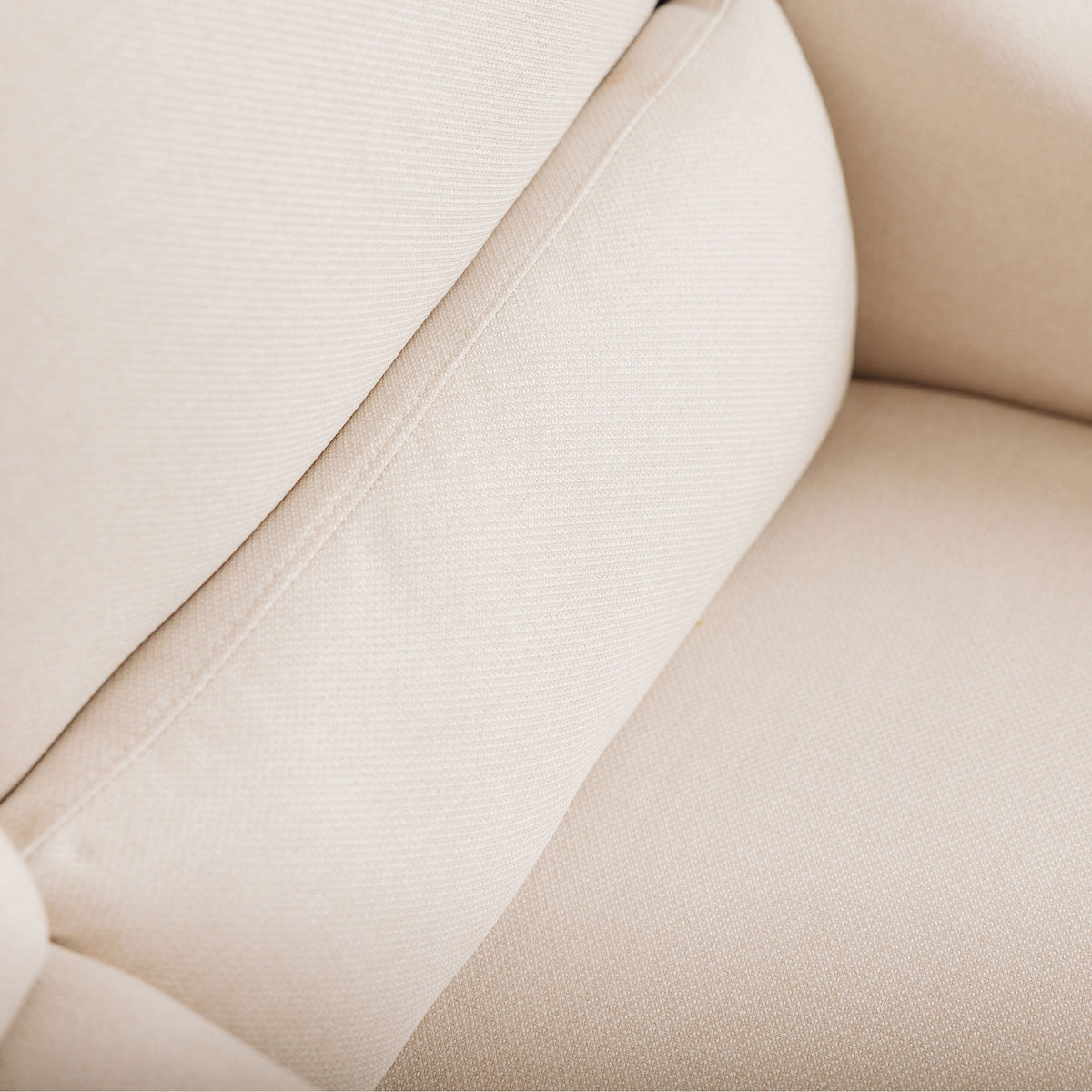 Close up of the Lyra Oat nursing chair back with supportive lumbar shaping.