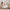 Mother holding her baby in the Gaia Baby Lyra nursing chair in Oat