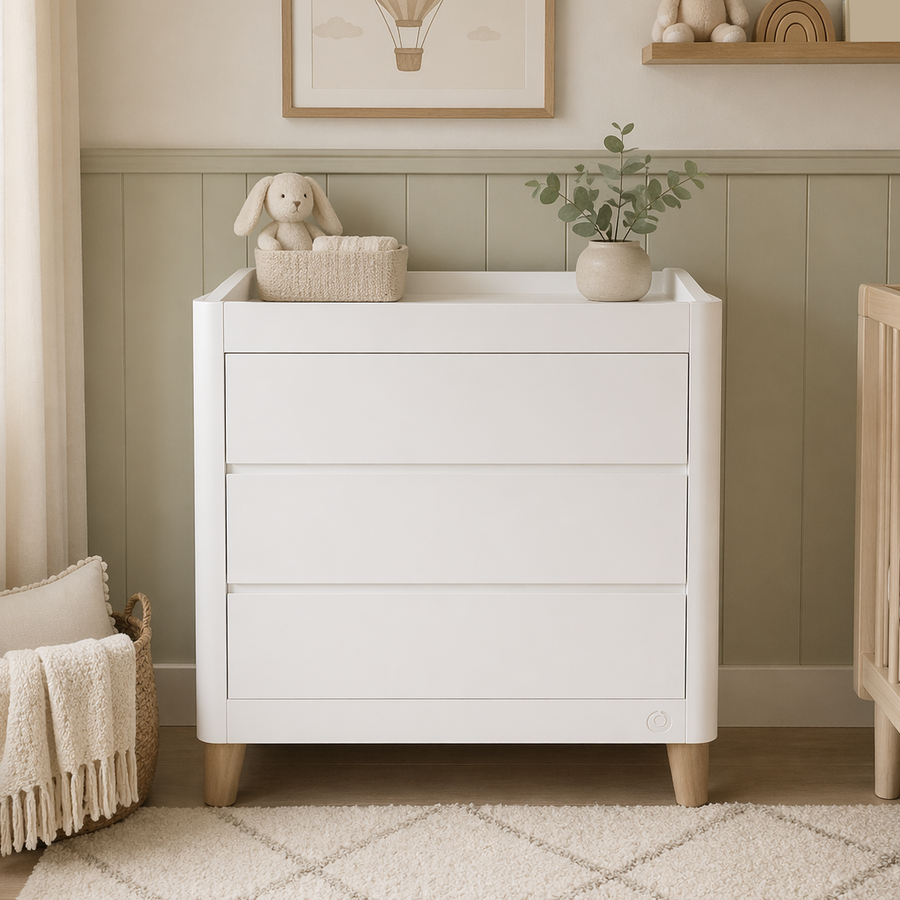 Gaia Baby Serena Dresser in white with natural wood accents, featuring multiple drawers for nursery storage.